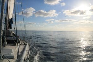 a sailboat sailing across a large body of water