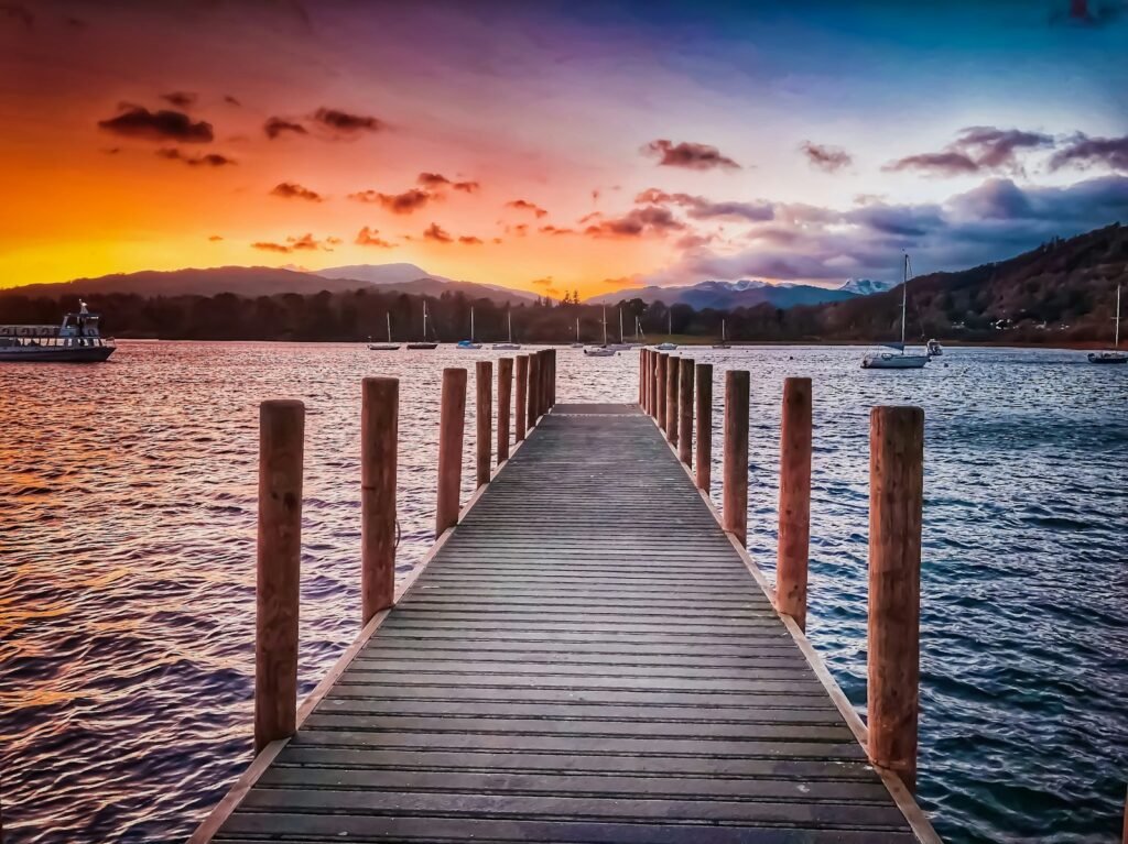 brown wooden dock near body of water during blue hour