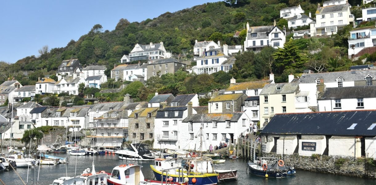 a harbor filled with lots of boats next to a hillside