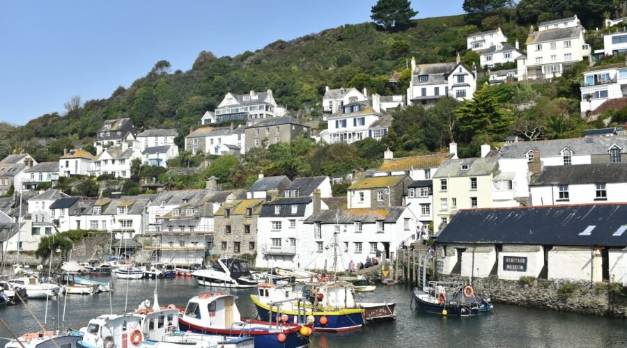 a harbor filled with lots of boats next to a hillside